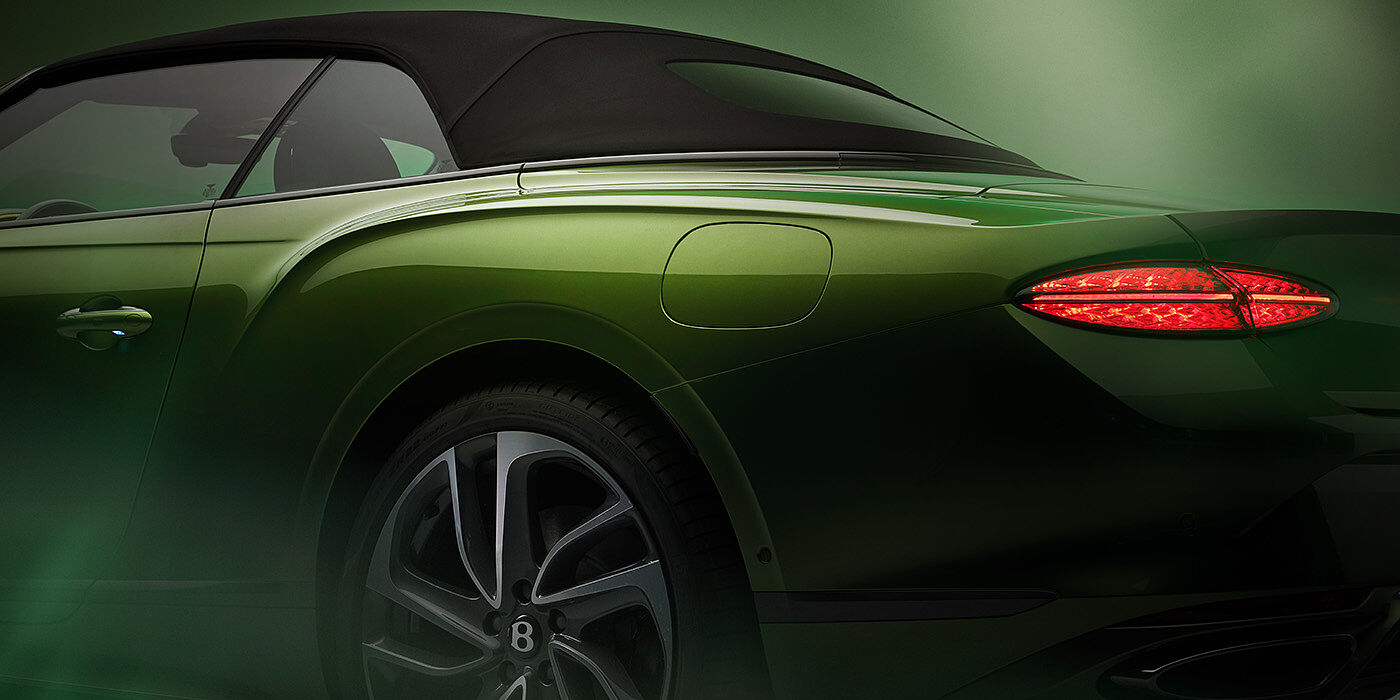 Bentley Essex (Chelmsford) Bentley New Continental GTC Speed rear haunch and tail lamp in Tourmaline Green paint and dark tint brightware with black hood up and illuminated head lamps