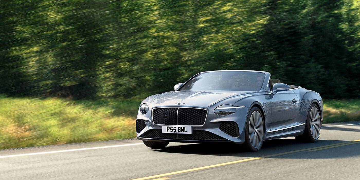 Bentley Essex (Chelmsford) New Bentley Continental GTC convertible front view in Silverlake paint with 22 inch ten spoke wheels, driving dynamically on a country road