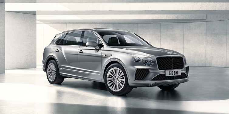 Bentley Essex (Chelmsford) Bentley Bentayga Extended Wheelbase SUV front three quarter in Moonbeam paint with a grey background
