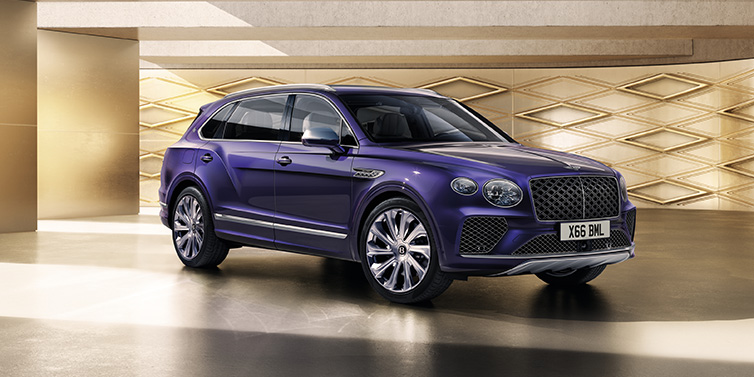 Bentley Essex (Chelmsford) Bentley Bentayga Extended Wheelbase Mulliner SUV front three quarter in Tanzanite Purple paint with a gold patterned background