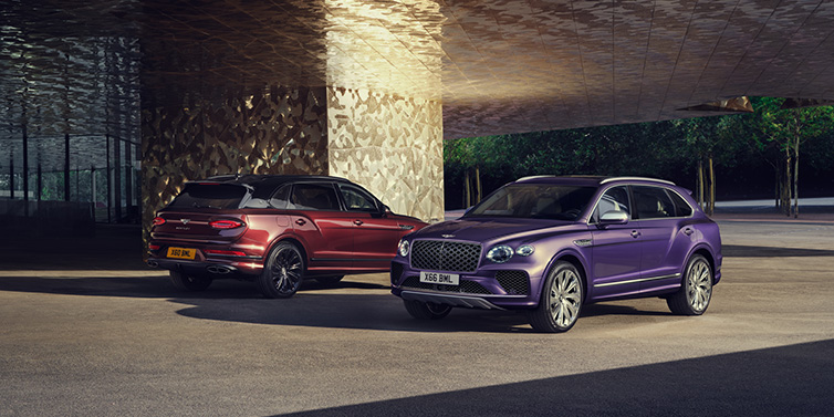 Bentley Essex (Chelmsford) A duo of Bentley Bentayga Extended Wheelbase Mulliner SUVs parked in a city environment, with Tanzanite Purple and Cricket Ball red exterior paint