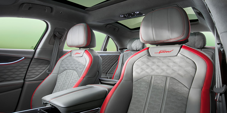 Bentley Essex (Chelmsford) Bentley Flying Spur Speed sedan interior showing front and rear seats in Hotspur red and Gravity Grey hides, with Speed seat emblems