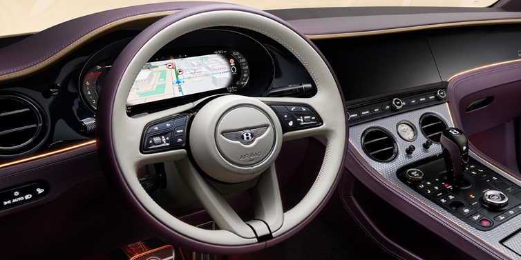 Bentley Essex (Chelmsford) Bentley Continental GT Mulliner coupe front interior showing steering wheel and drivers screens surrounded by Linen and Damson hides and Grand Black veneer